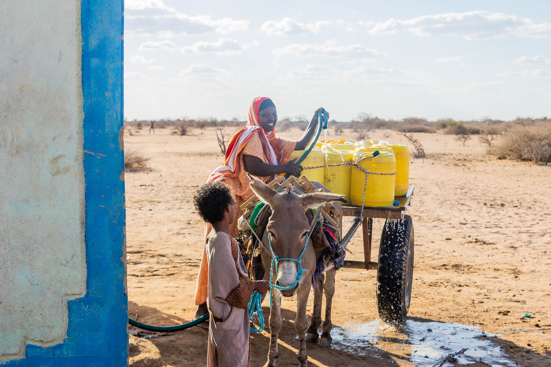 Dakan Abdi Fetching water in a water kiosk in Guticha, Wajir County